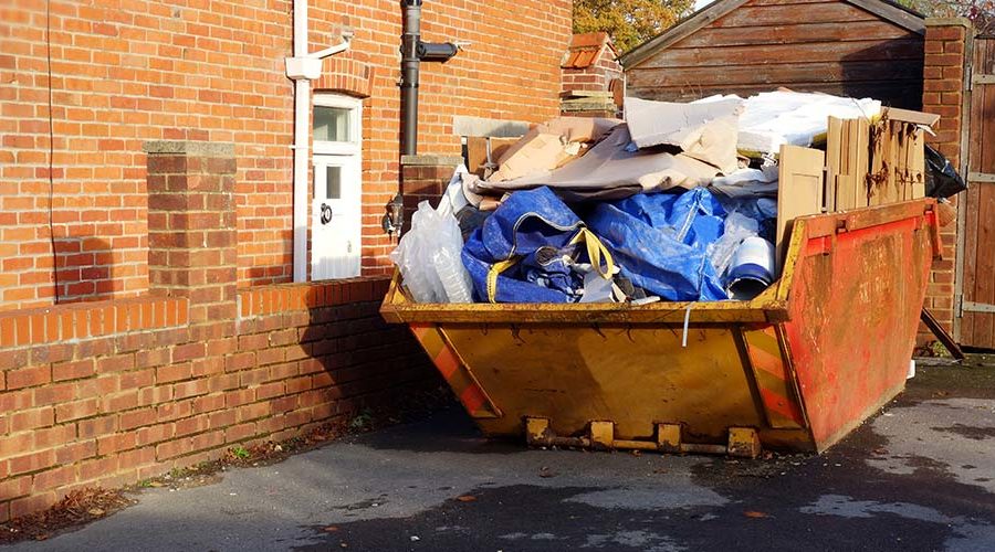 skip on driveway filled with waste