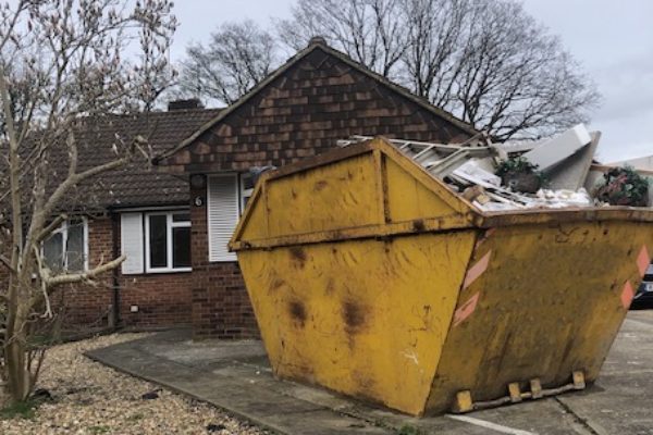Large skip filled with rubbish in Southville