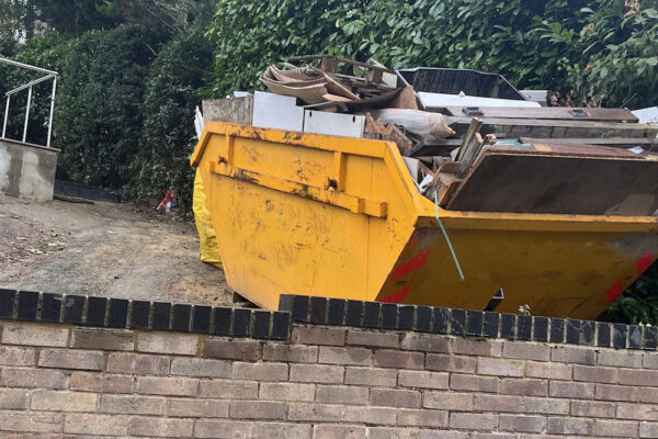Skip filled with building materials in Crawley, UK