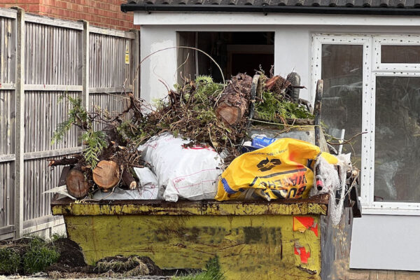 Skip filled with garden waste in Charlwood, UK