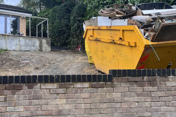 Skip filled with building materials ready for collection in Tadley, UK