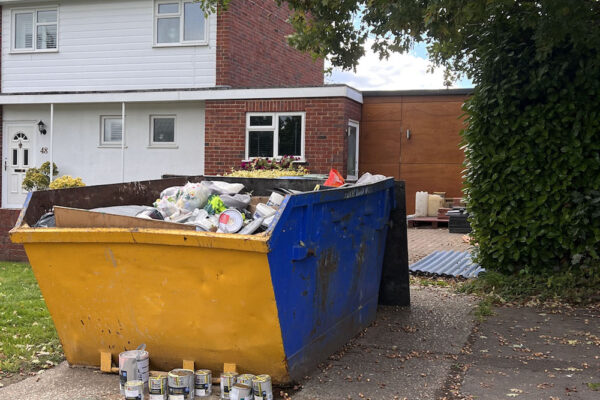 Paint cans in hired skip in Witchford, UK