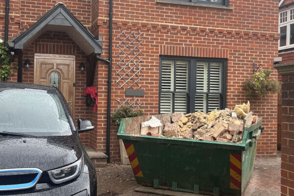 Small skip filled with rubble and other building materials in Stourbridge
